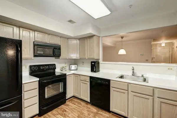 a kitchen with a sink stove and microwave