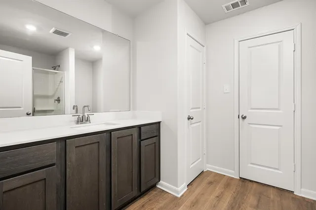 a bathroom with a double vanity sink and a mirror