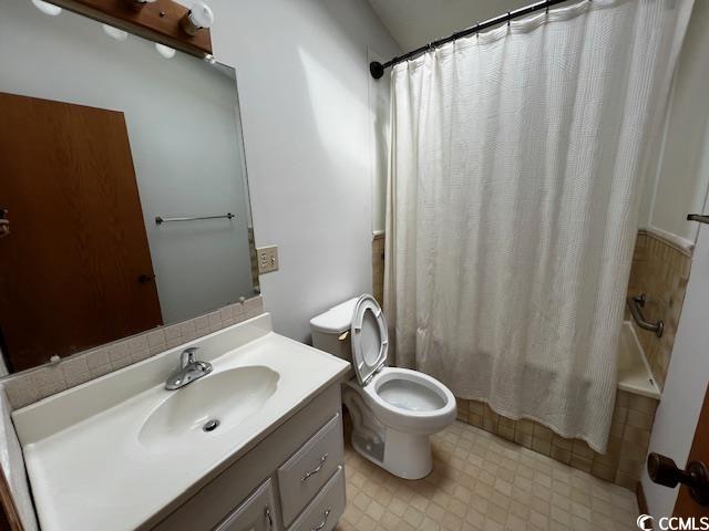 310 Lakeside Drive, Unit A Surfside Beach, SC 29575 - Photo 11 of 13 Bathroom with vanity, toilet, and tile patterned f
