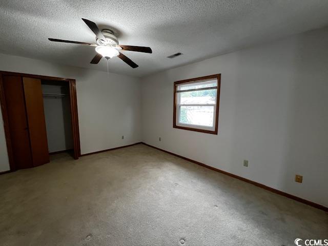 310 Lakeside Drive, Unit A Surfside Beach, SC 29575 - Photo 6 of 13 Unfurnished bedroom featuring a closet, carpet, ce