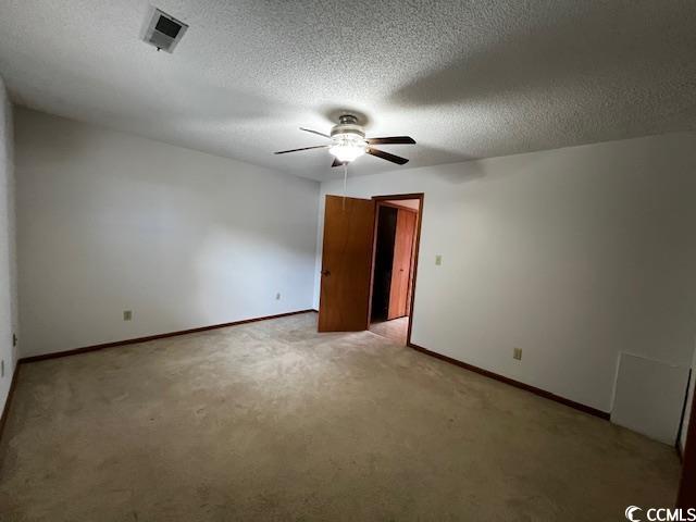 310 Lakeside Drive, Unit A Surfside Beach, SC 29575 - Photo 7 of 13 Carpeted spare room featuring a textured ceiling a