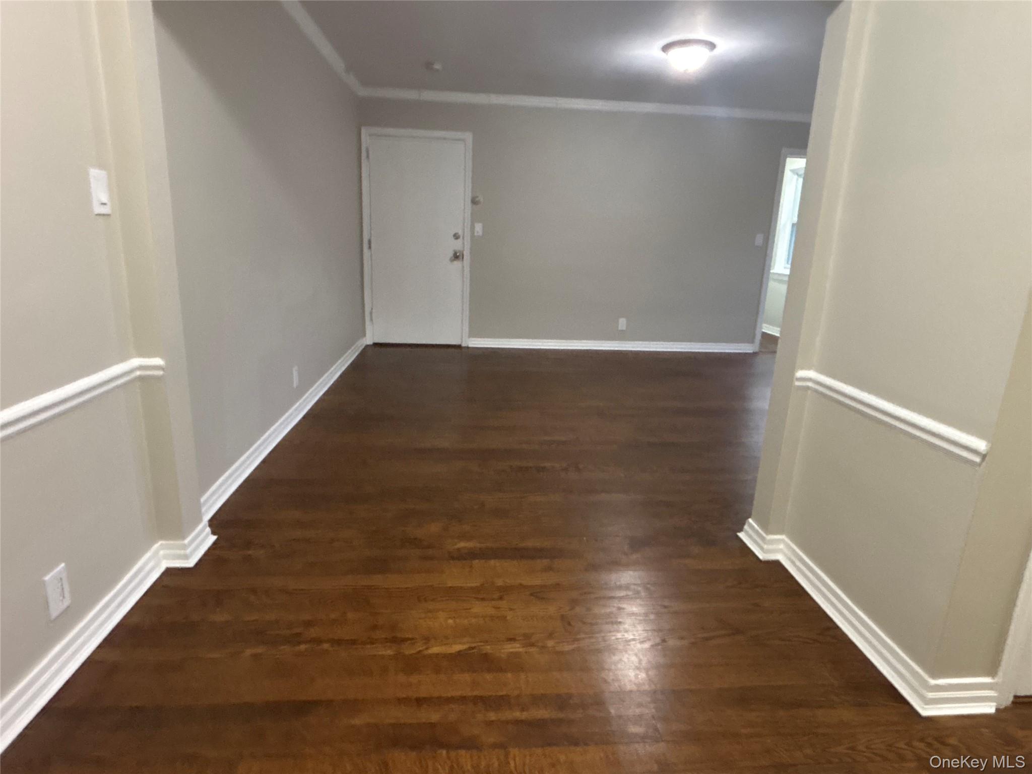 37 Spruce Street, Unit 3 Great Neck, NY 11021 - Photo 8 of 15 Corridor featuring dark wood-style flooring and crown molding