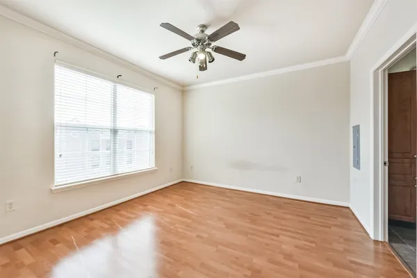 wooden floor in an empty room with a window