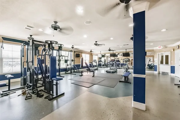 a room with furniture pool table and windows