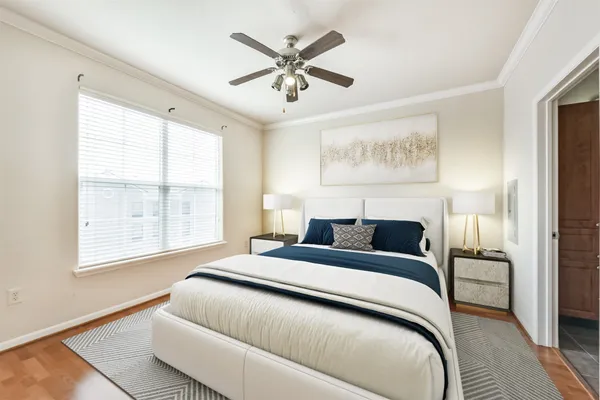 a hallway with white cabinets and wooden floor