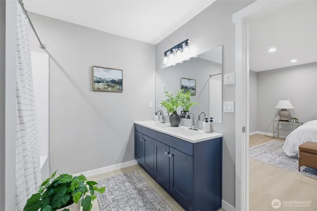 a bathroom with a sink a toilet and a mirror