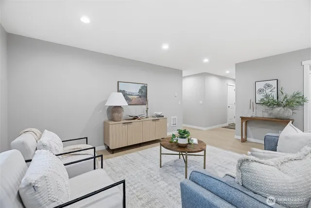 a living room with furniture and a potted plant