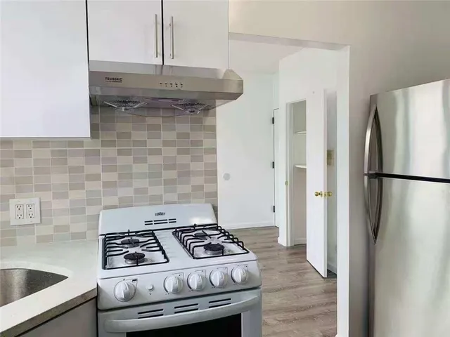 a stove top oven sitting inside of a kitchen