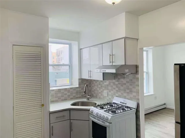 a kitchen that has a sink and a stove in it