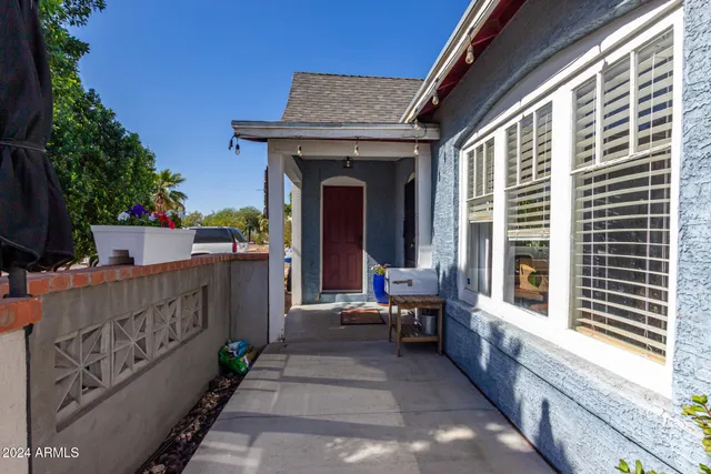 a view of a house with sitting area and garden