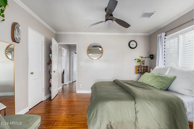 a bedroom with a bed and a large window