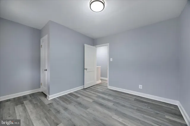 a view of a room with wooden floor and window