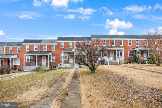 a front view of a building with a garden