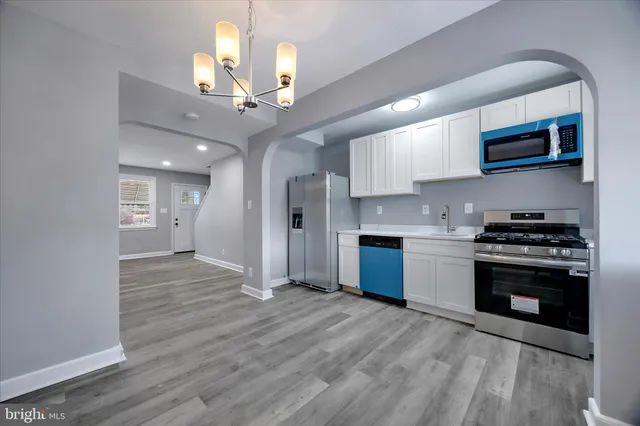 a kitchen with stainless steel appliances granite countertop a stove a sink and a refrigerator