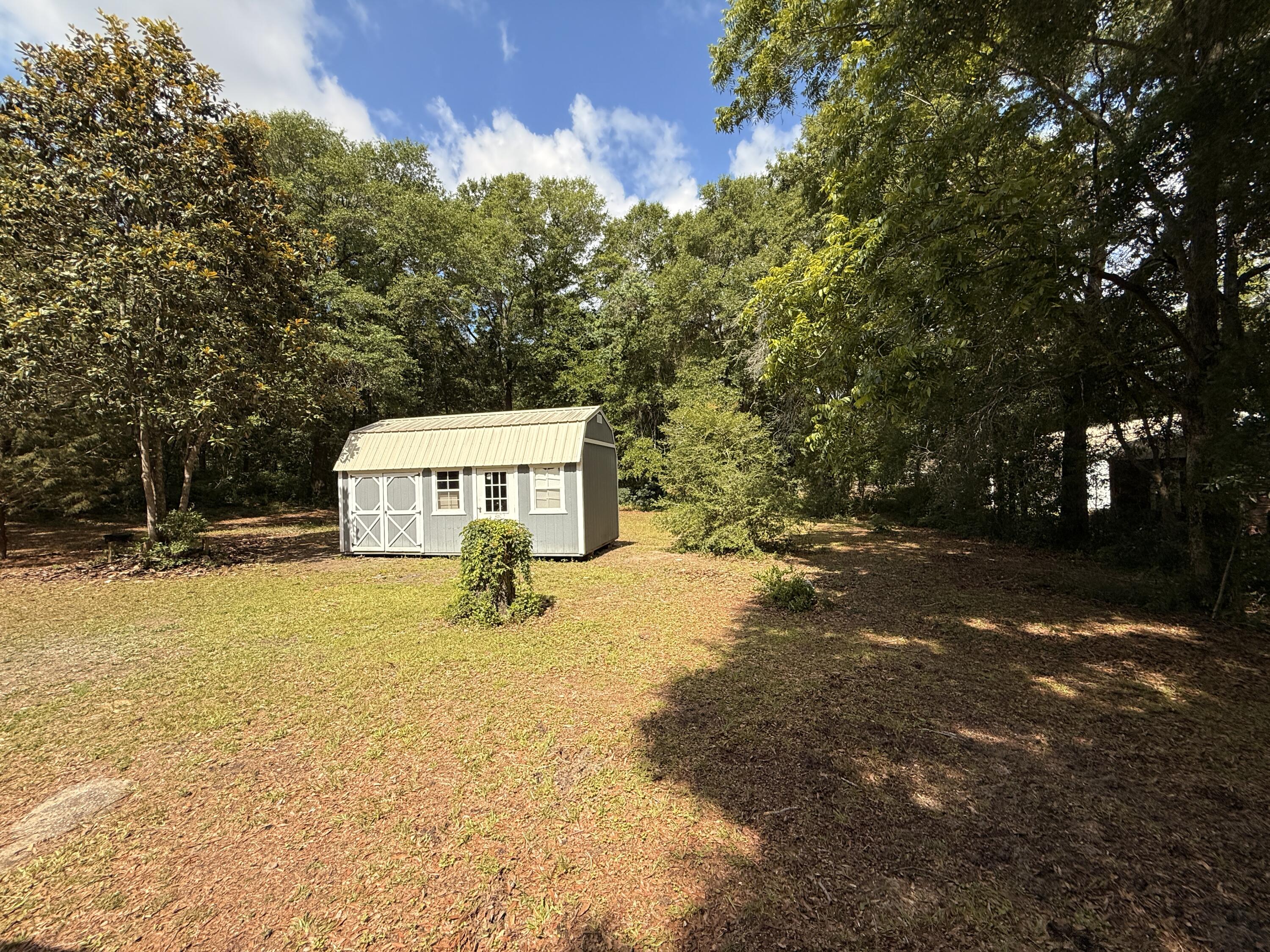299 Carl Place Crestview, FL 32539 - Photo 13 of 37 a yellow swimming pool with trees in the background