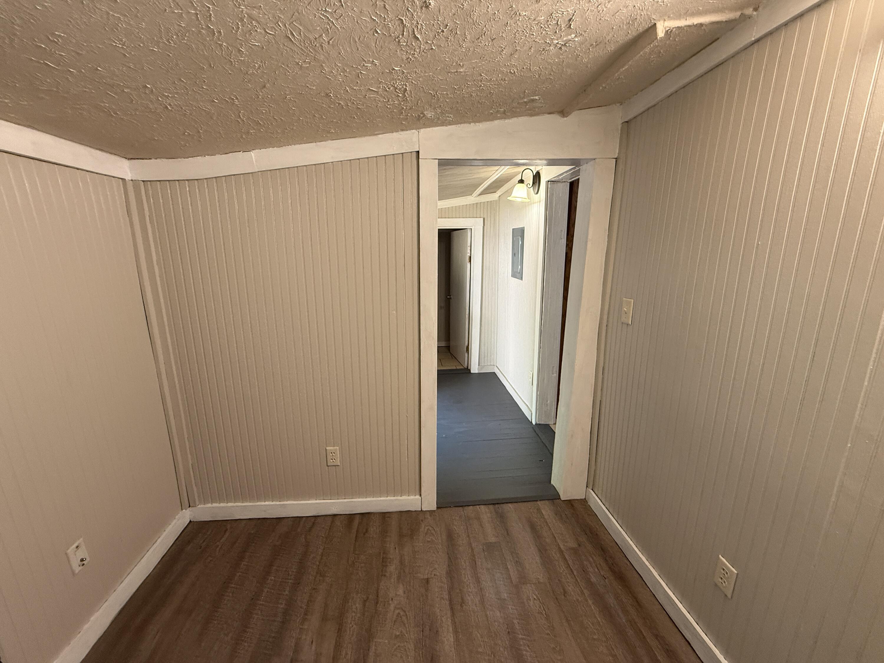 299 Carl Place Crestview, FL 32539 - Photo 18 of 37 a view of an empty room with wooden floor