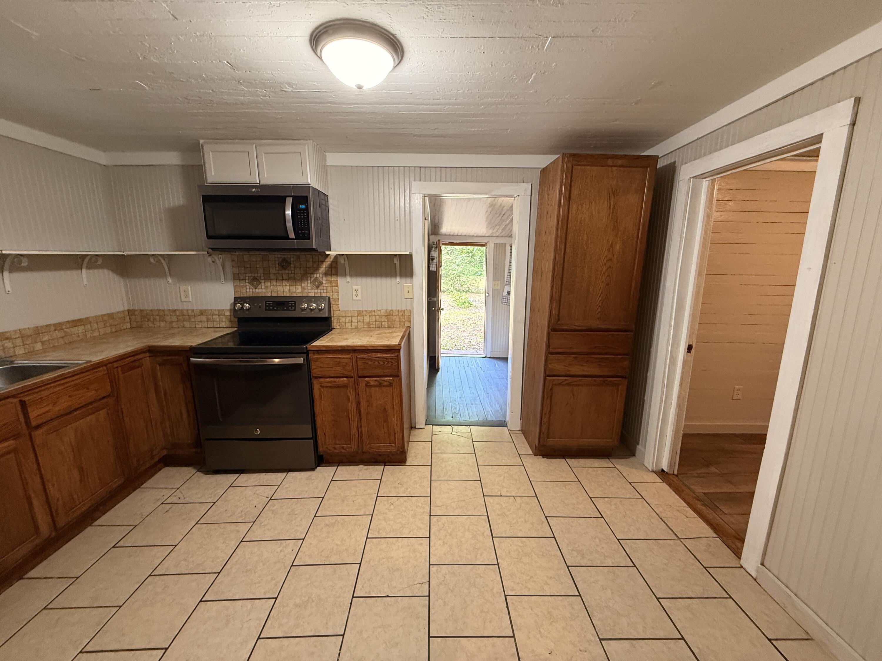 299 Carl Place Crestview, FL 32539 - Photo 24 of 37 a kitchen with stainless steel appliances granite countertop a refrigerator and a sink