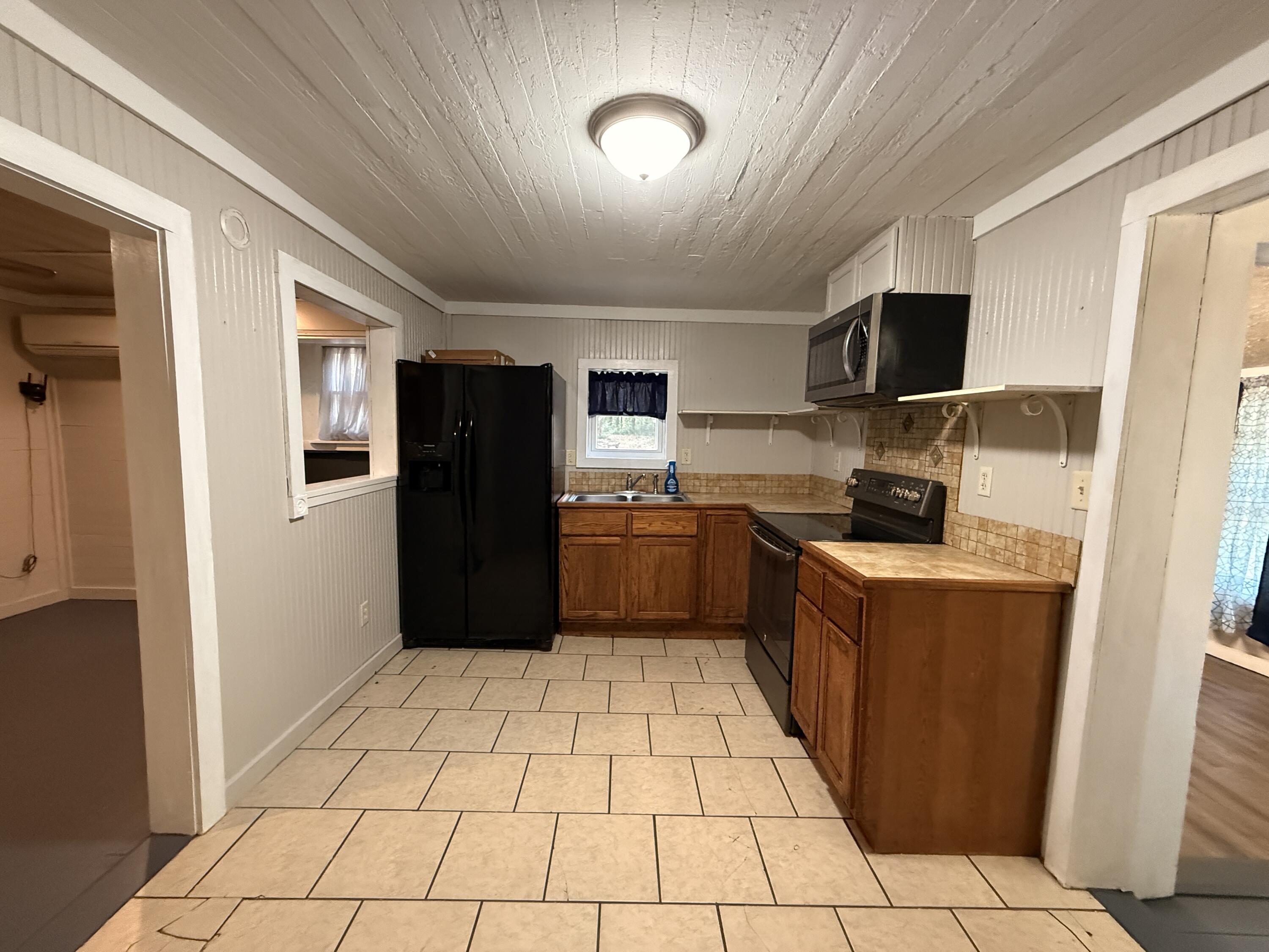 299 Carl Place Crestview, FL 32539 - Photo 25 of 37 a kitchen with stainless steel appliances granite countertop a refrigerator and a sink