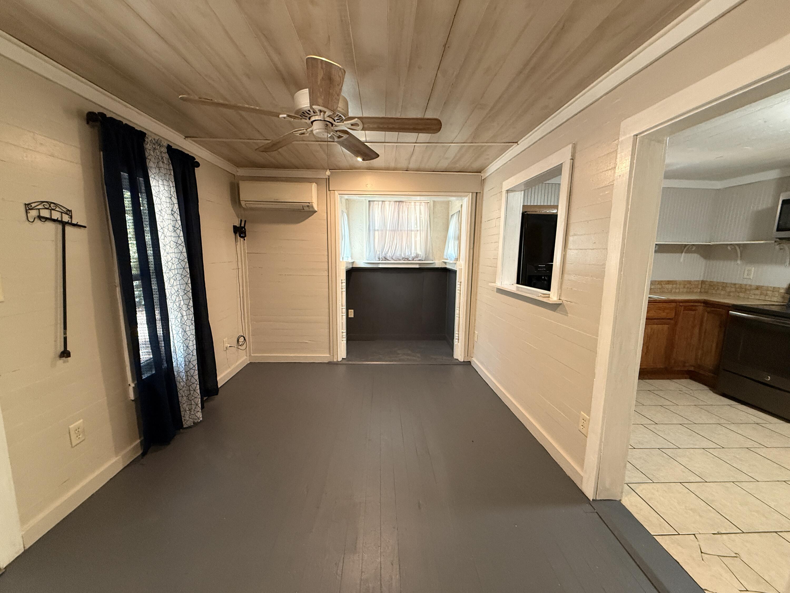 299 Carl Place Crestview, FL 32539 - Photo 29 of 37 a view of a big room with wooden floor and windows