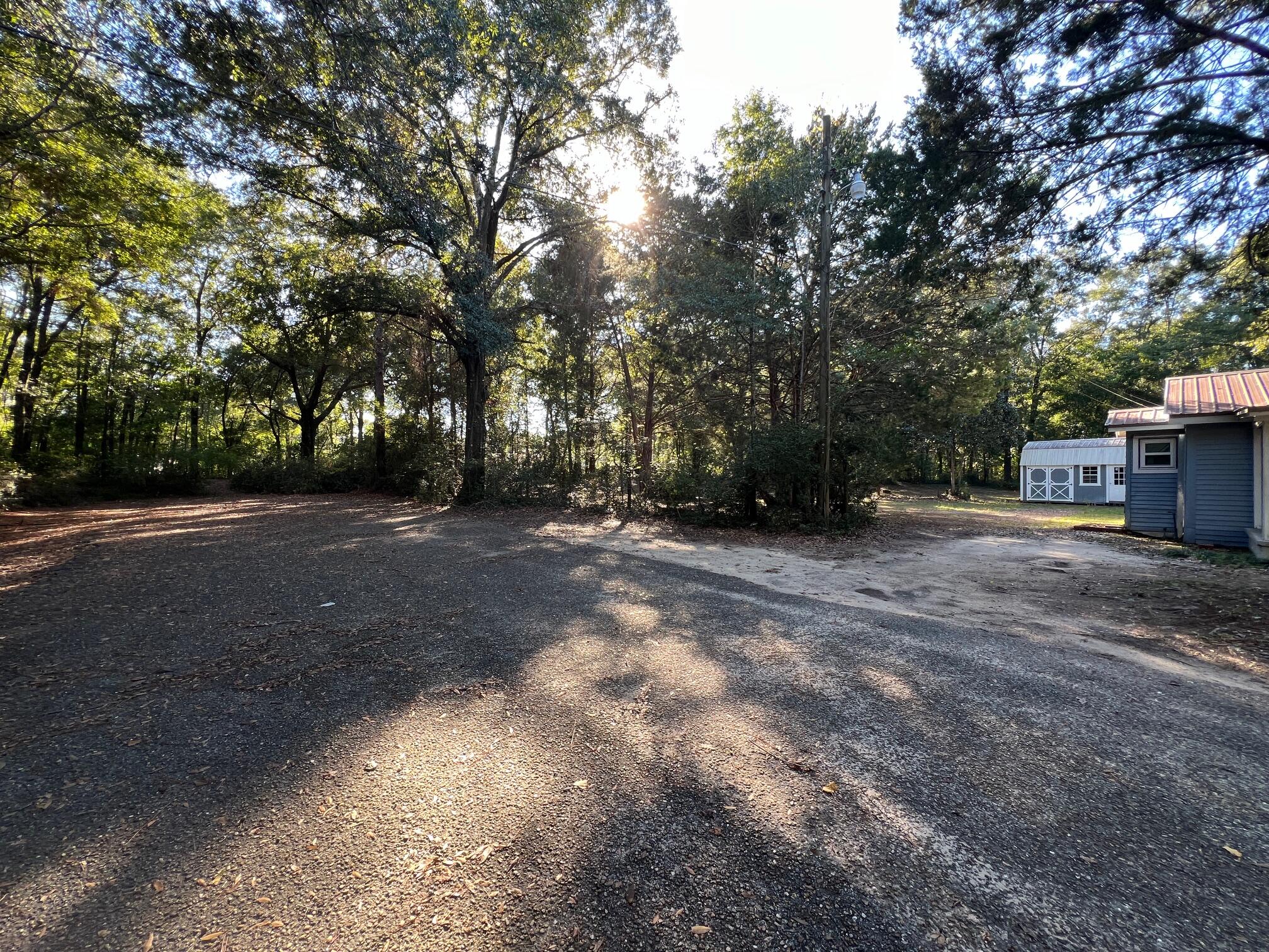 299 Carl Place Crestview, FL 32539 - Photo 31 of 37 a view of a field with trees in front of it