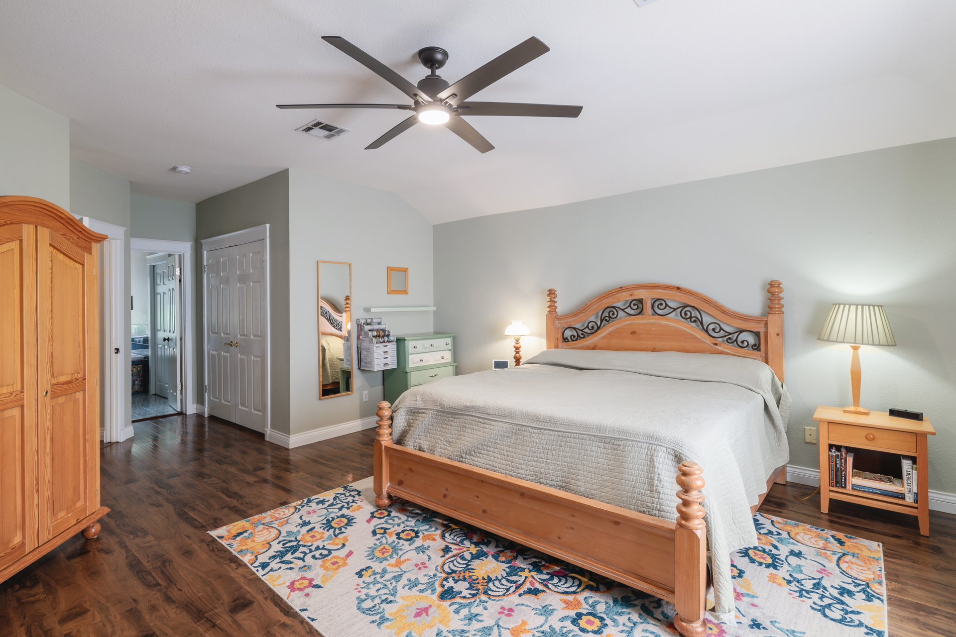 7000 Bending Oak Road Austin, TX 78749 - Photo 20 of 39 a bedroom with a bed a dresser and wooden floor