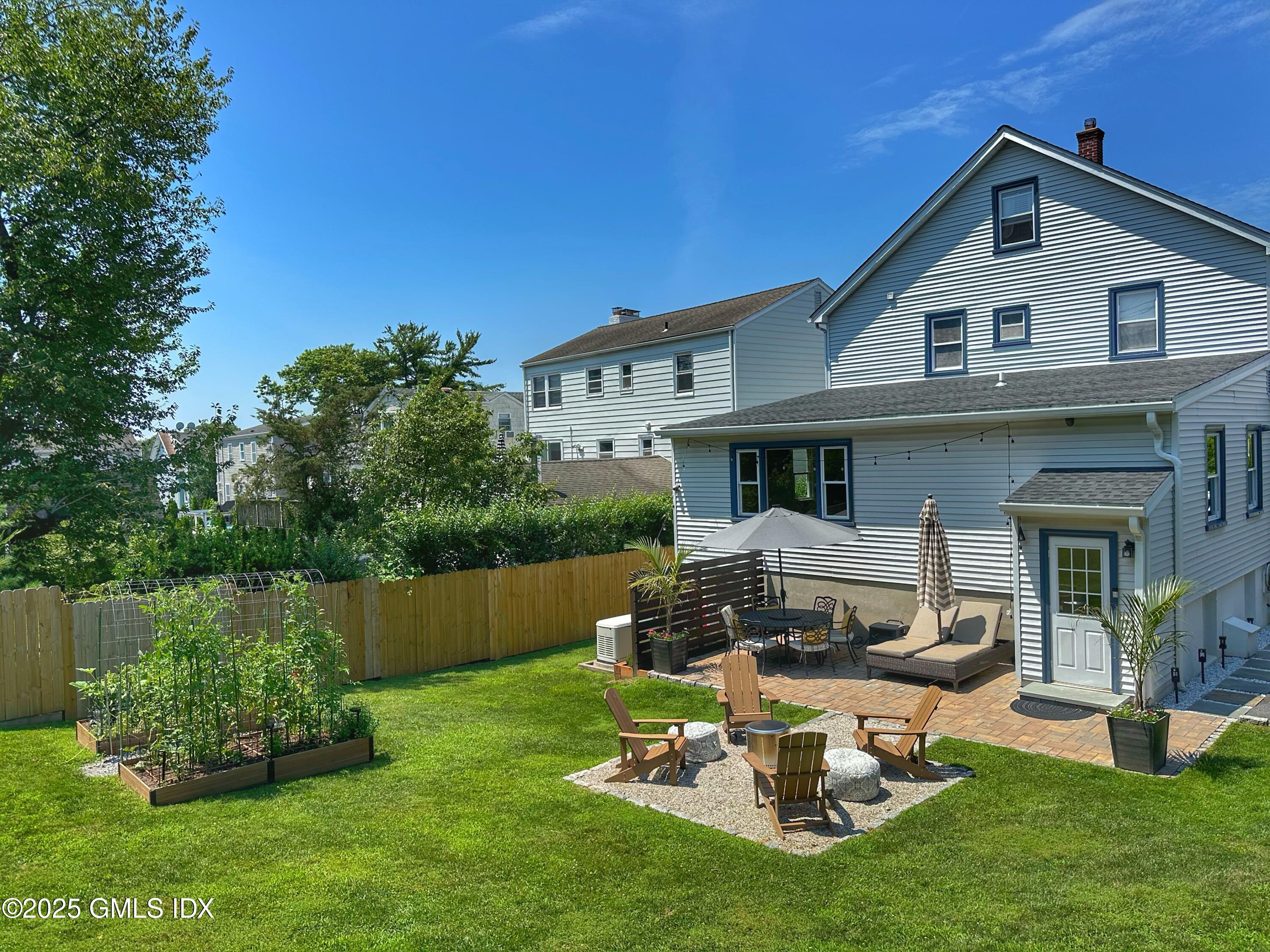 37 Gerry Street, Unit 2 Greenwich, CT 06830 - Photo 11 of 13 a front view of a house with a garden and plants