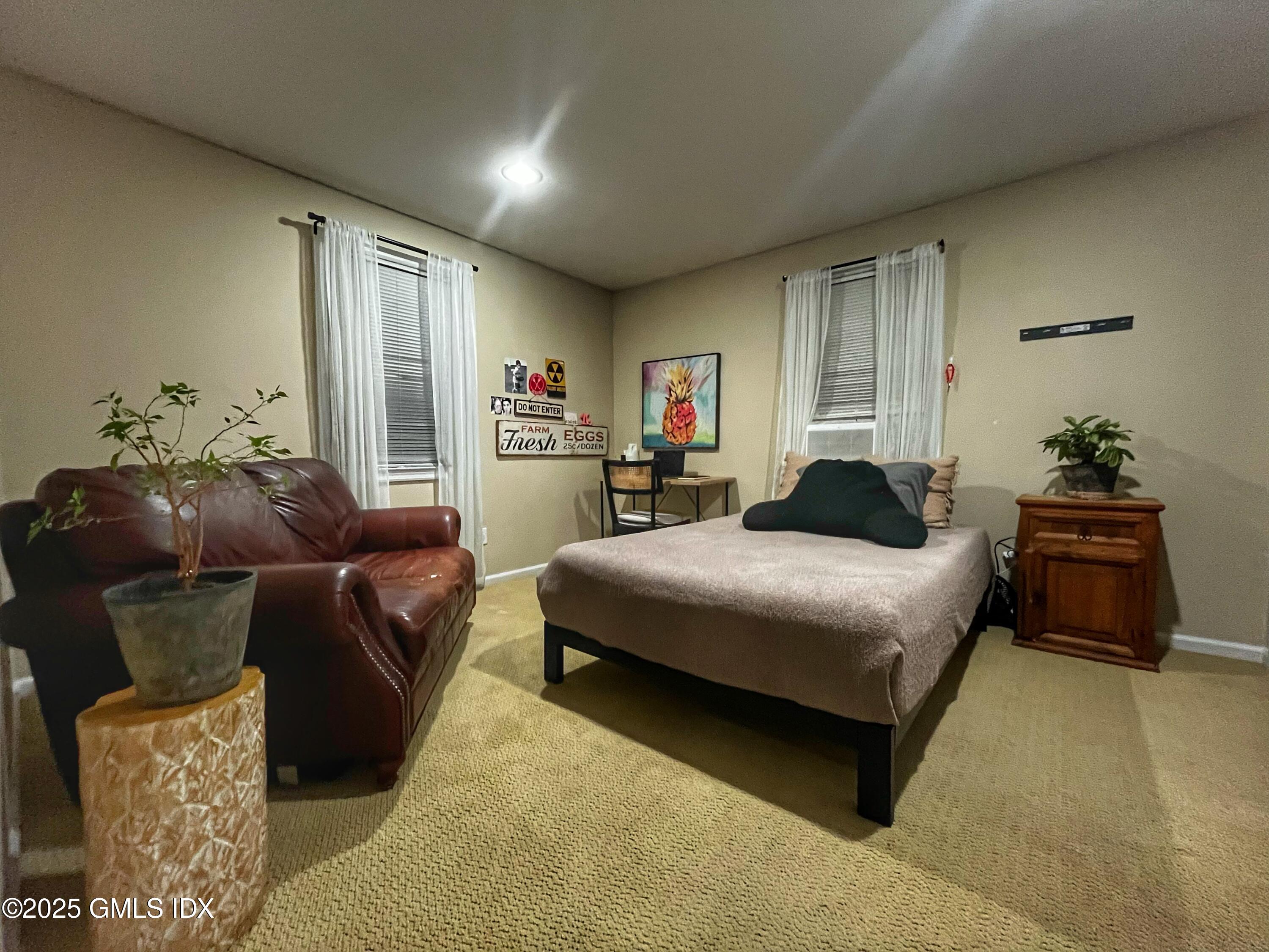 37 Gerry Street, Unit 2 Greenwich, CT 06830 - Photo 8 of 13 a bedroom with a bed and wooden floor