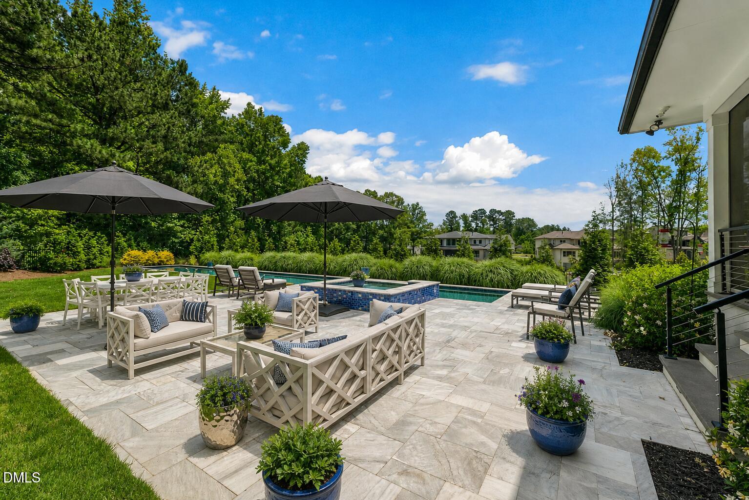 132 Edward Booth Lane Durham, NC 27713 - Photo 52 of 68 a view of a patio with couches table and chairs under an umbrella with a fire pit