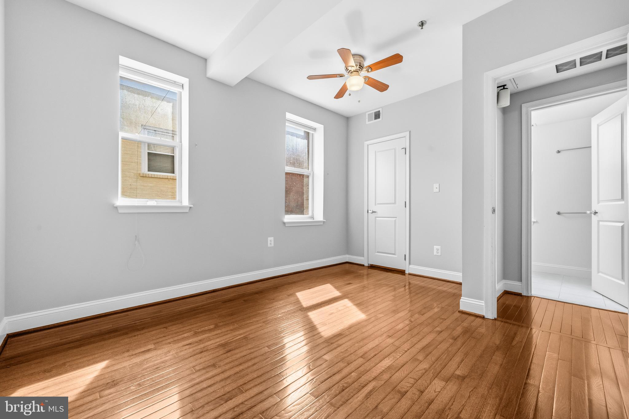 1831 2nd Street Northeast, Unit 207 Washington, DC 20002 - Photo 11 of 33 an empty room with wooden floor and windows