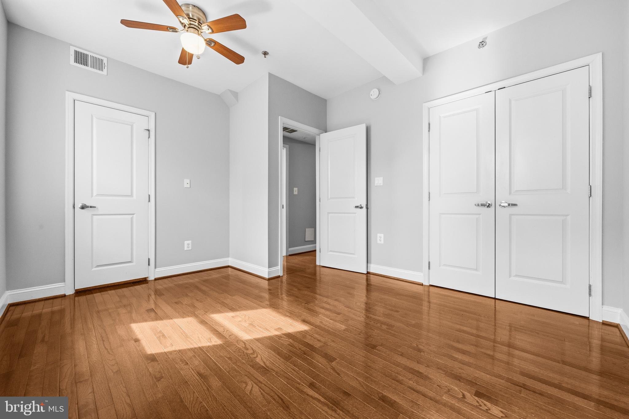 1831 2nd Street Northeast, Unit 207 Washington, DC 20002 - Photo 13 of 33 an empty room with wooden floor closet and windows