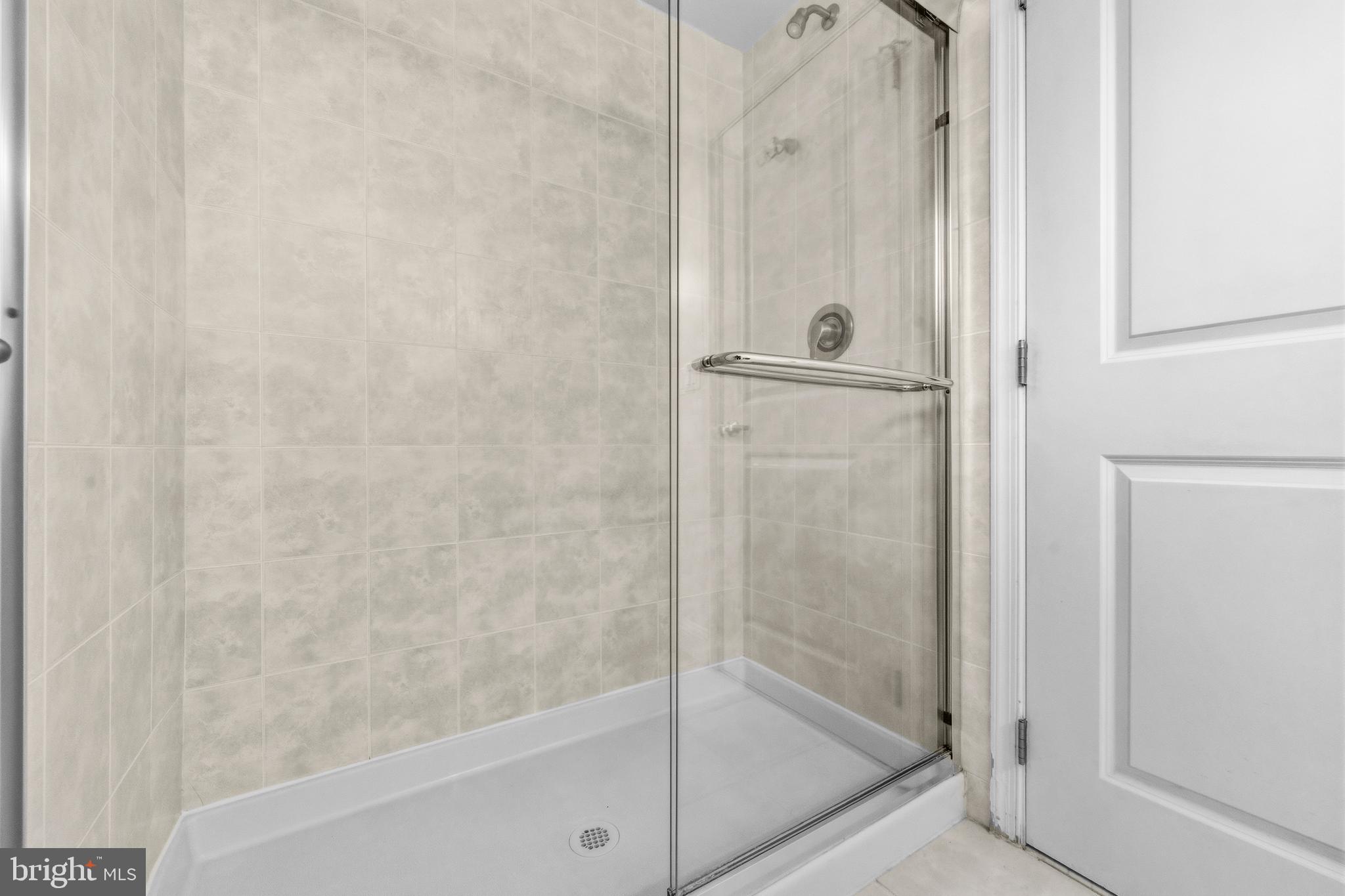1831 2nd Street Northeast, Unit 207 Washington, DC 20002 - Photo 15 of 33 a bathroom with a glass shower door
