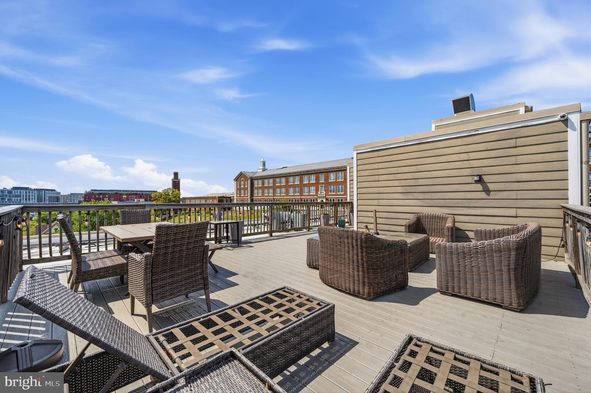 1831 2nd Street Northeast, Unit 207 Washington, DC 20002 - Photo 19 of 33 a roof deck with couch and chairs
