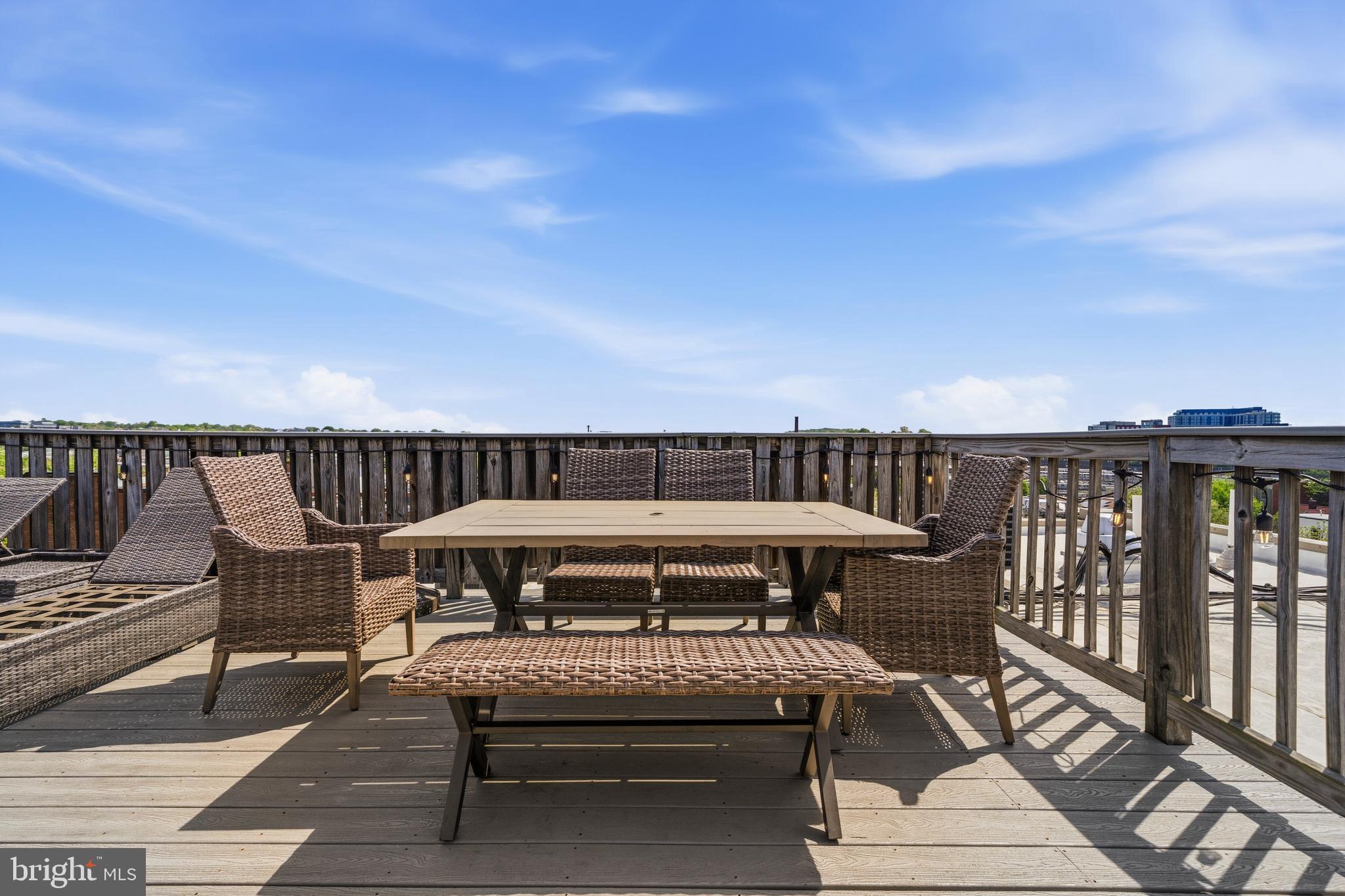 1831 2nd Street Northeast, Unit 207 Washington, DC 20002 - Photo 21 of 33 a roof deck with table and chairs a barbeque