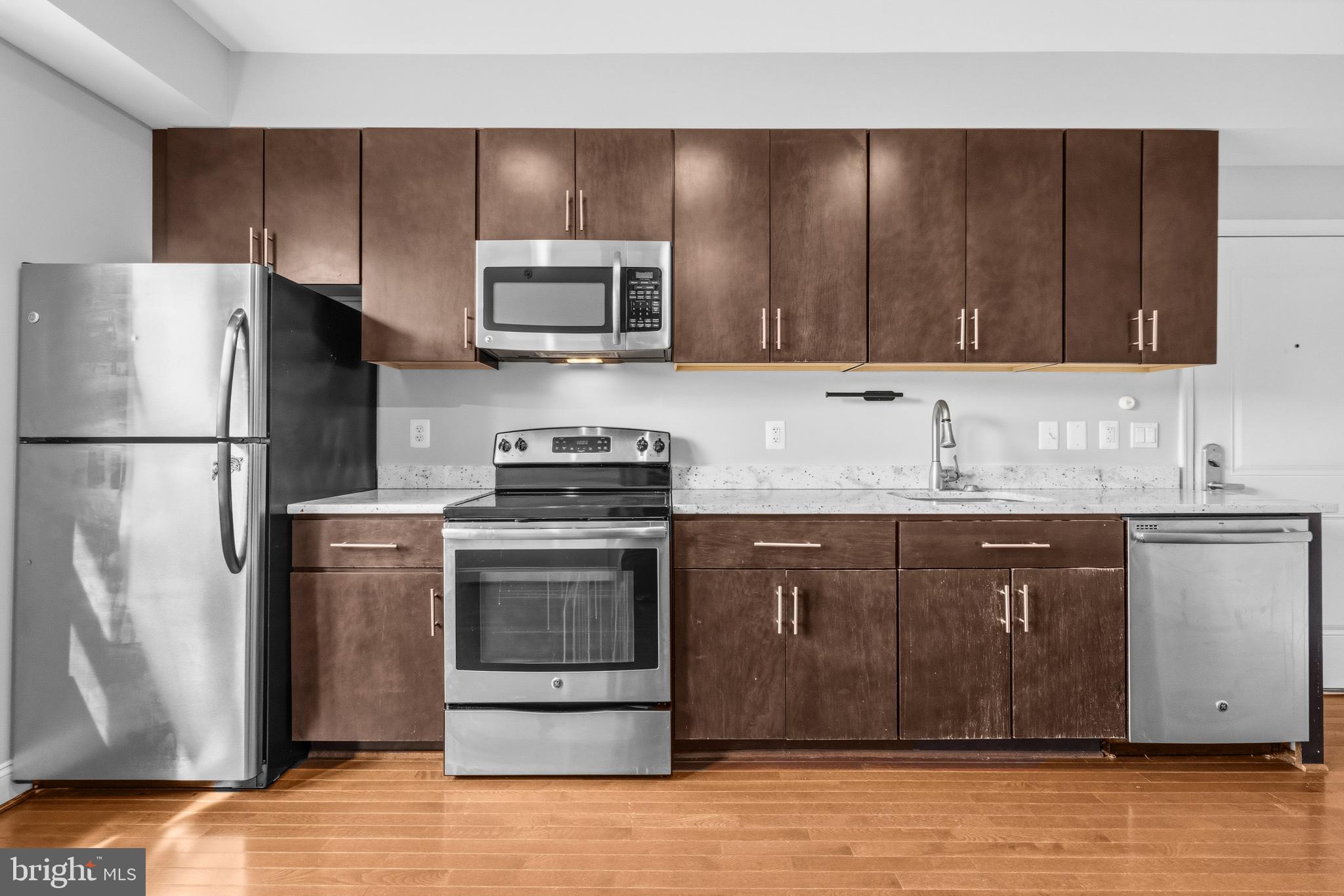 1831 2nd Street Northeast, Unit 207 Washington, DC 20002 - Photo 4 of 33 a kitchen with stainless steel appliances granite countertop a refrigerator stove a sink and dishwasher