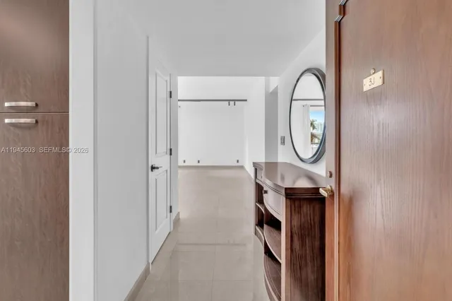 a view of a livingroom with furniture and mirror