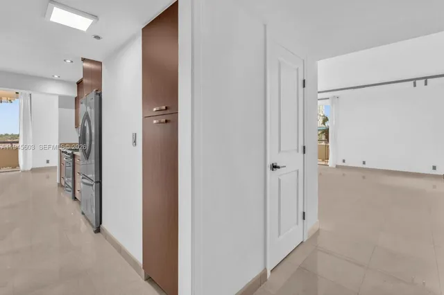 a view of a hallway with a closet and a room