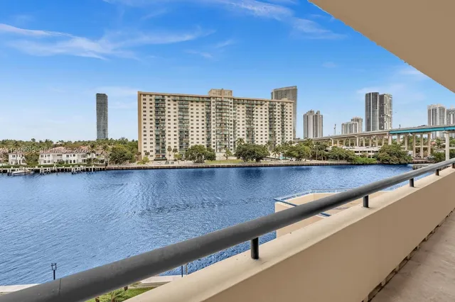 a view of swimming pool with outdoor seating and city view