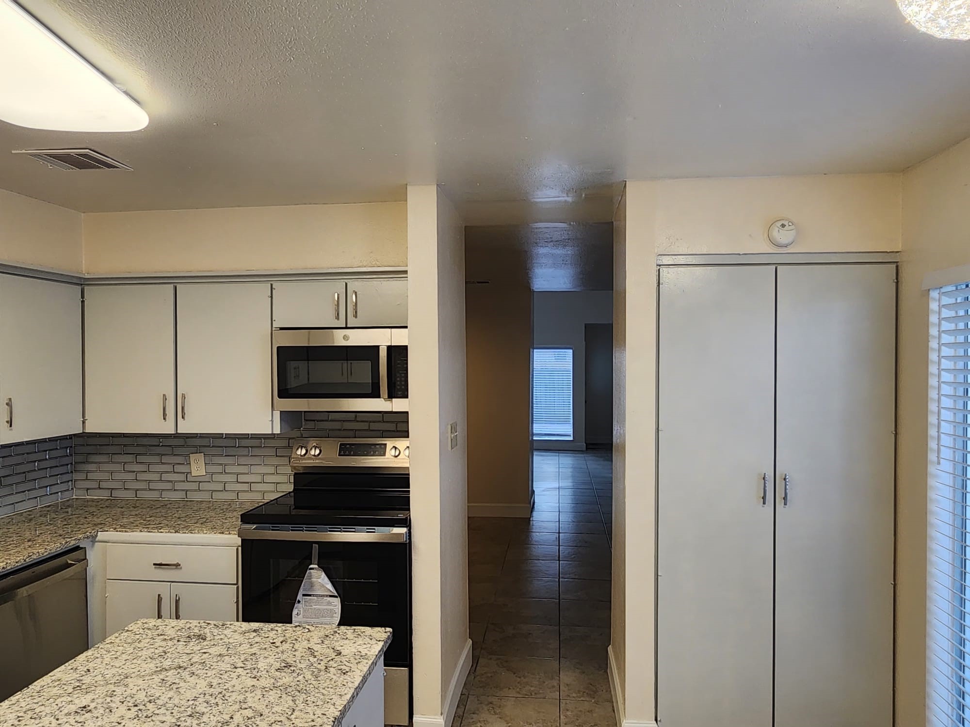 12534 Riva Ridge Lane Missouri City, TX 77071 - Photo 16 of 28 a kitchen with a refrigerator stove and microwave