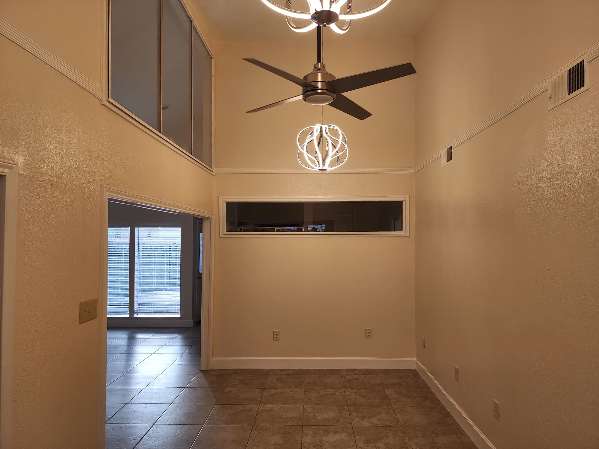 12534 Riva Ridge Lane Missouri City, TX 77071 - Photo 17 of 28 a view of a hallway with a chandelier