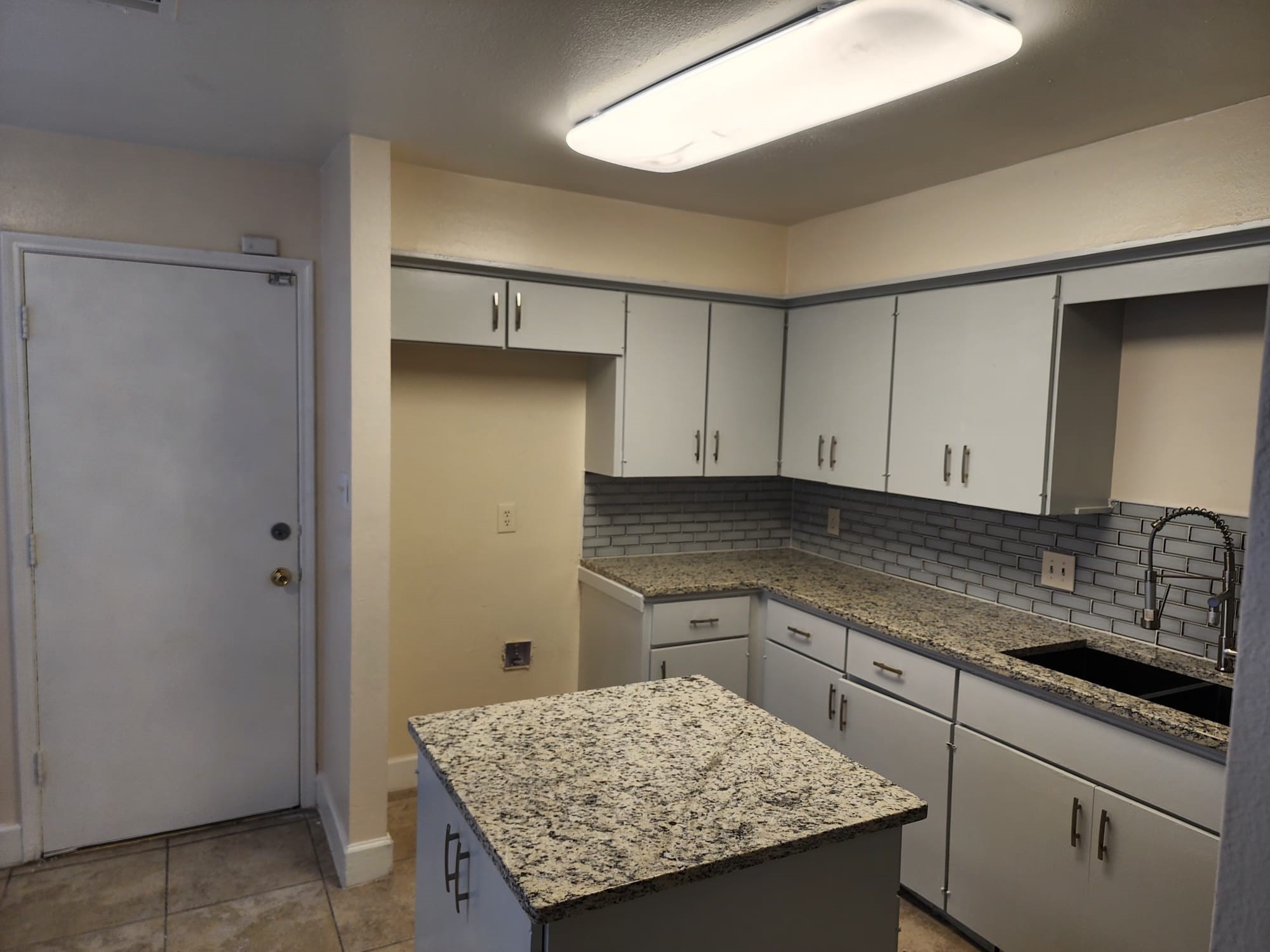12534 Riva Ridge Lane Missouri City, TX 77071 - Photo 18 of 28 a kitchen with a sink refrigerator and cabinets