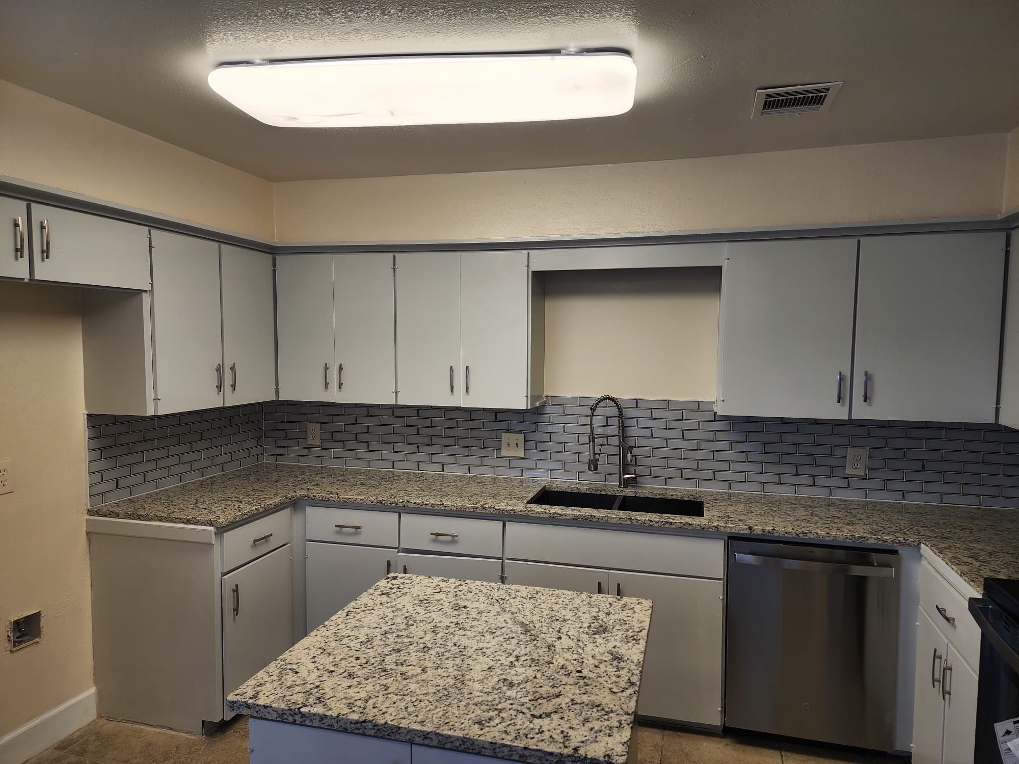 12534 Riva Ridge Lane Missouri City, TX 77071 - Photo 4 of 28 a kitchen with stainless steel appliances granite countertop a sink stove and cabinets