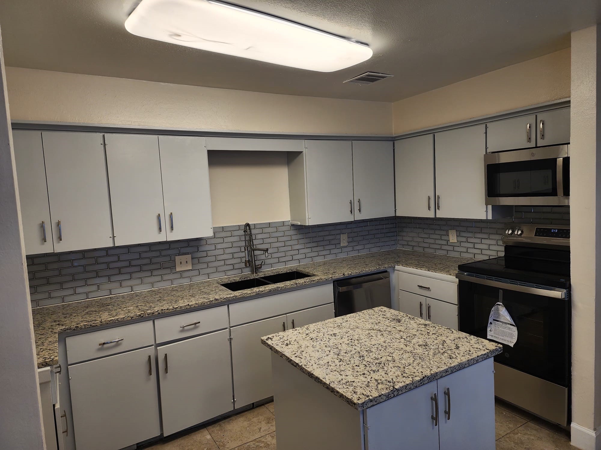 12534 Riva Ridge Lane Missouri City, TX 77071 - Photo 5 of 28 a kitchen with granite countertop cabinets sink and stainless steel appliances