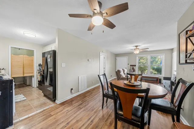 a view of a dining room with furniture window and wooden floor