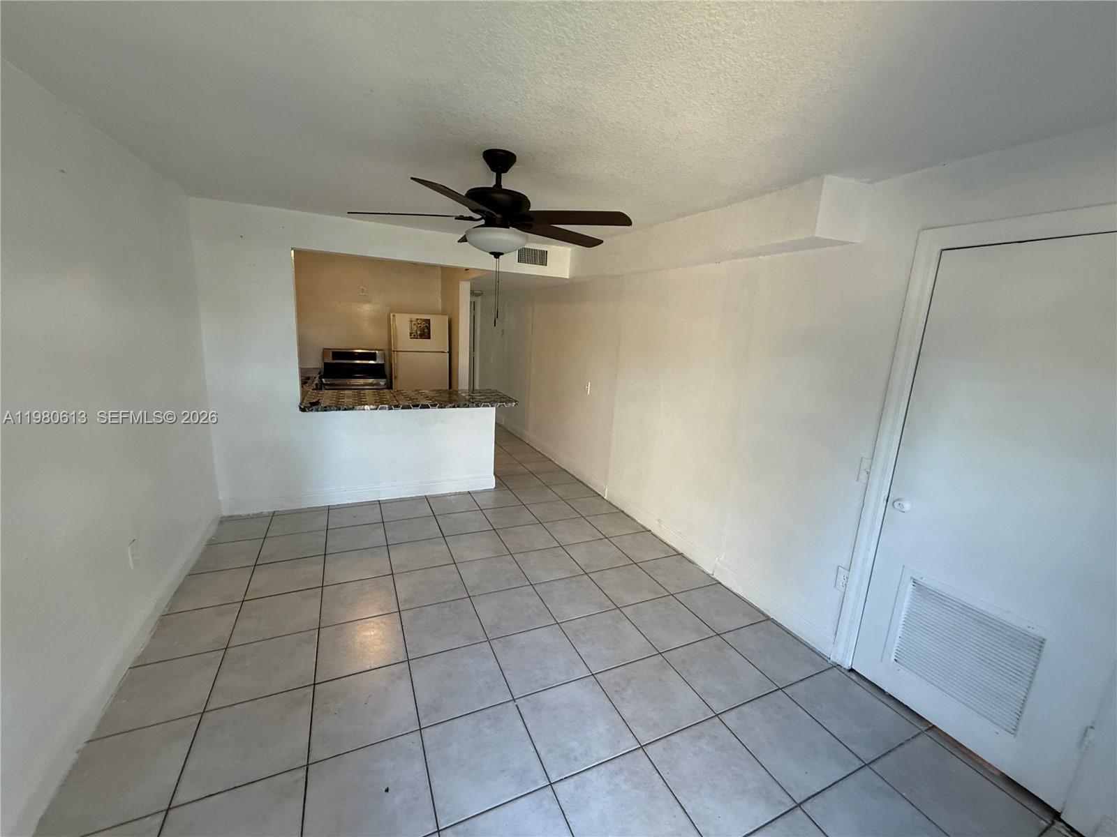 11317 Southwest 187th Terrace, Unit 4 Miami, FL 33157 - Photo 1 of 7 a view of an empty room and a window