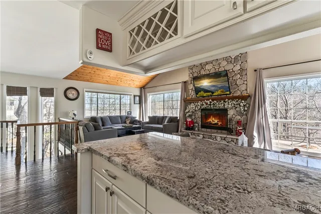 a view of living room with furniture and a fireplace