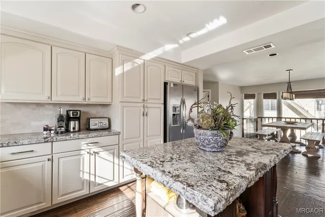 a kitchen with stainless steel appliances granite countertop a sink stove and refrigerator
