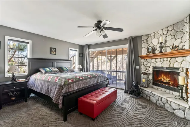 a bedroom with a bed a couch and dresser