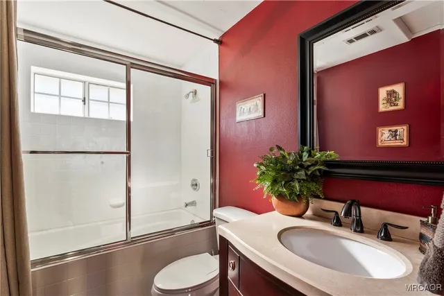 a bathroom with a sink vanity granite and a mirror