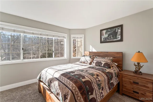 a bed sitting in a bedroom next to a window