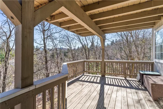 a view of a balcony with wooden floor and iron stairs